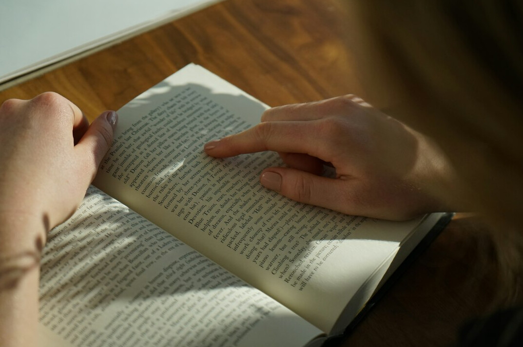 person reading book on self improvement