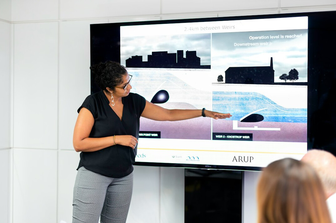 woman presenting to colleagues