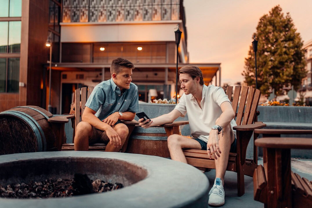 Two friends having a warm conversation outdoors